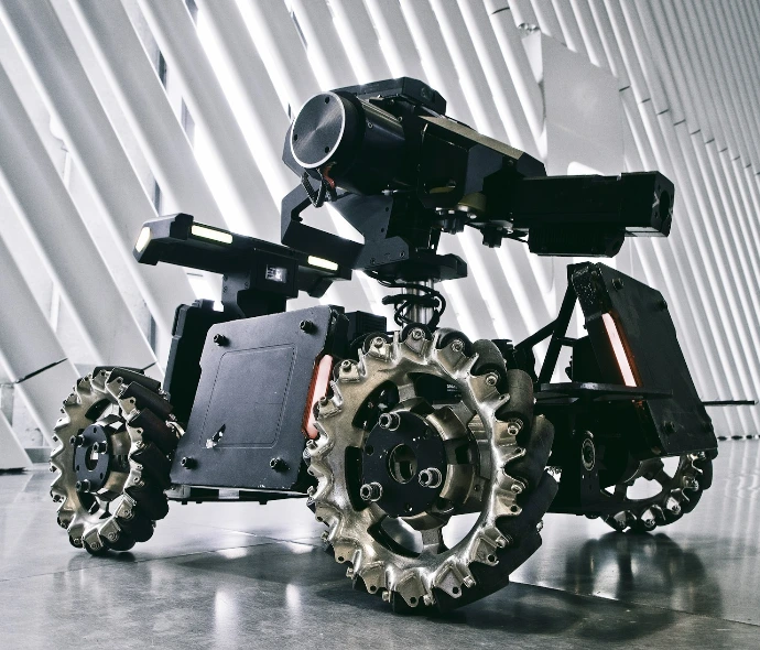 A black and white photo of a camera on wheels